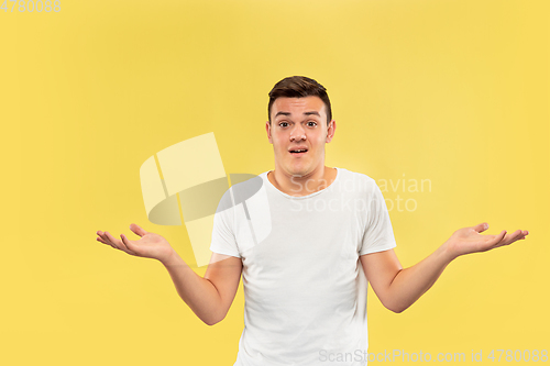 Image of Caucasian young man\'s half-length portrait on yellow background