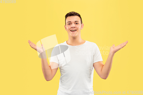 Image of Caucasian young man\'s half-length portrait on yellow background