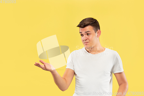 Image of Caucasian young man\'s half-length portrait on yellow background