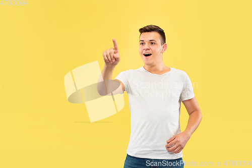 Image of Caucasian young man\'s half-length portrait on yellow background