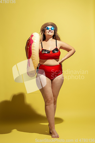 Image of Young caucasian plus size female model\'s preparing for beach resort