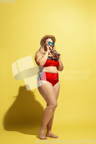 Image of Young caucasian plus size female model\'s preparing for beach resort