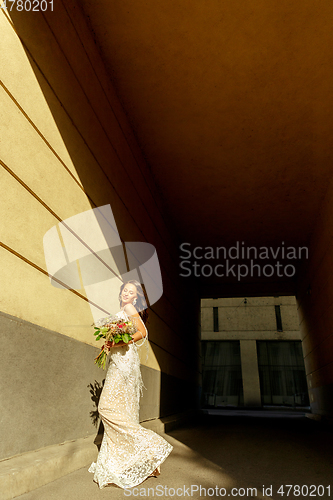 Image of Caucasian romantic young groom celebrating his marriage in city