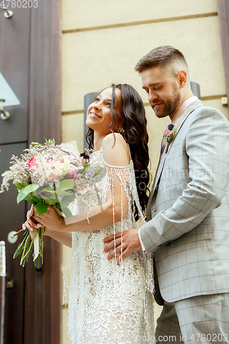 Image of Caucasian romantic young couple celebrating their marriage in city