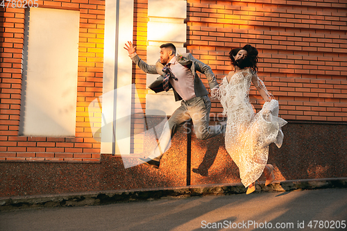 Image of Caucasian romantic young couple celebrating their marriage in city