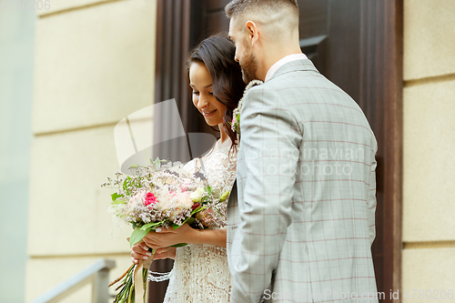 Image of Caucasian romantic young couple celebrating their marriage in city