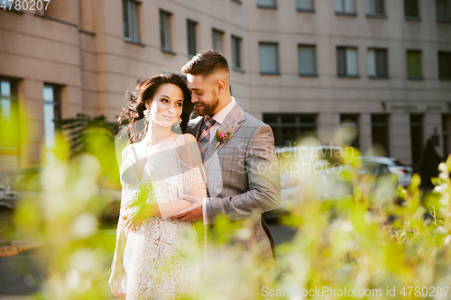 Image of Caucasian romantic young couple celebrating their marriage in city