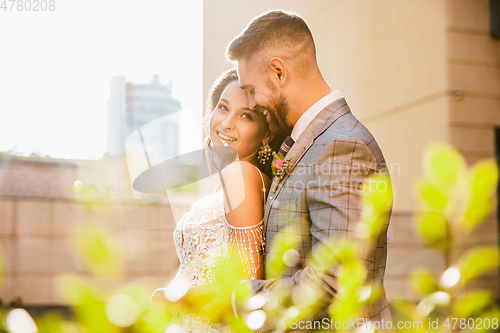 Image of Caucasian romantic young couple celebrating their marriage in city