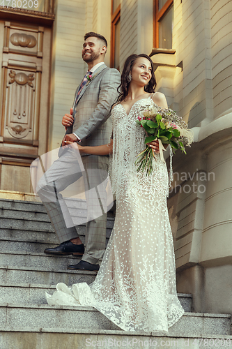 Image of Caucasian romantic young couple celebrating their marriage in city