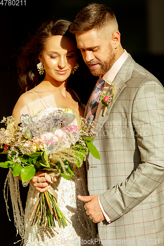 Image of Caucasian romantic young couple celebrating their marriage in city