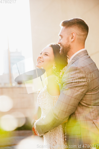 Image of Caucasian romantic young couple celebrating their marriage in city