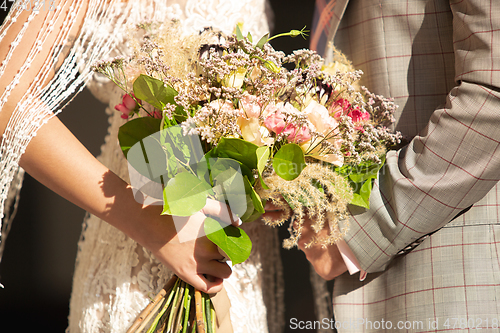 Image of Caucasian romantic young couple celebrating their marriage in city