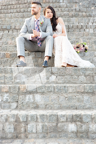 Image of Caucasian romantic young couple celebrating their marriage in city