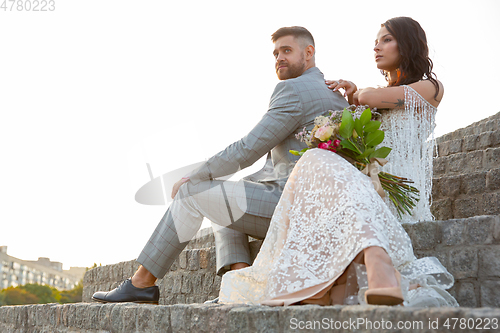 Image of Caucasian romantic young couple celebrating their marriage in city