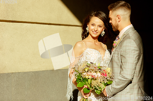 Image of Caucasian romantic young couple celebrating their marriage in city