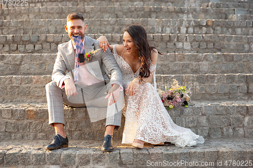 Image of Caucasian romantic young couple celebrating their marriage in city