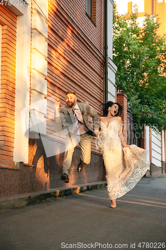 Image of Caucasian romantic young couple celebrating their marriage in city