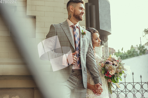 Image of Caucasian romantic young couple celebrating their marriage in city