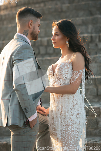 Image of Caucasian romantic young couple celebrating their marriage in city