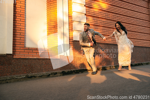 Image of Caucasian romantic young couple celebrating their marriage in city