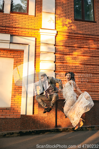 Image of Caucasian romantic young couple celebrating their marriage in city