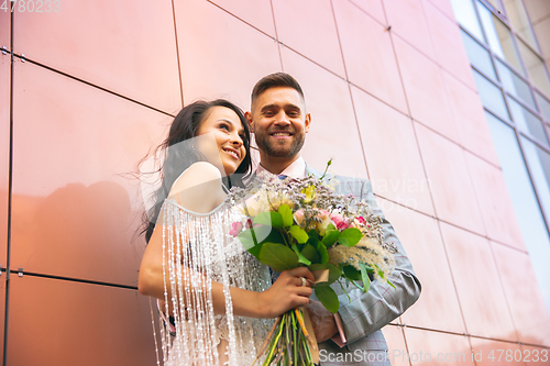 Image of Caucasian romantic young couple celebrating their marriage in city