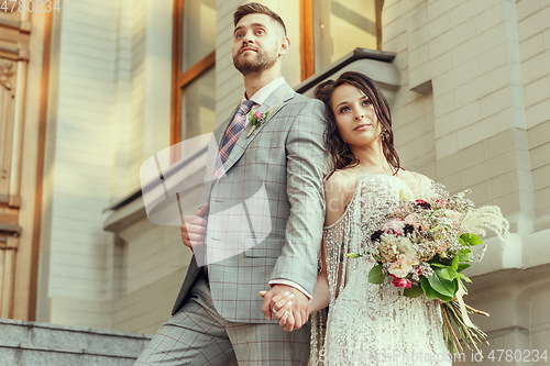 Image of Caucasian romantic young couple celebrating their marriage in city