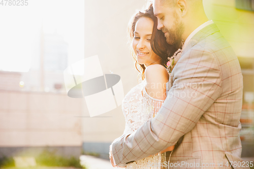 Image of Caucasian romantic young couple celebrating their marriage in city