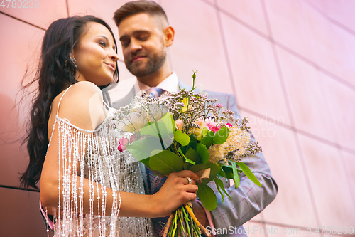 Image of Caucasian romantic young couple celebrating their marriage in city