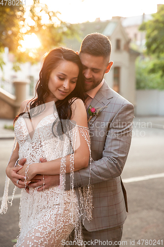 Image of Caucasian romantic young couple celebrating their marriage in city