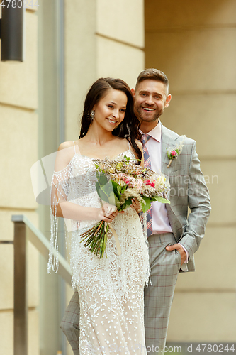 Image of Caucasian romantic young couple celebrating their marriage in city