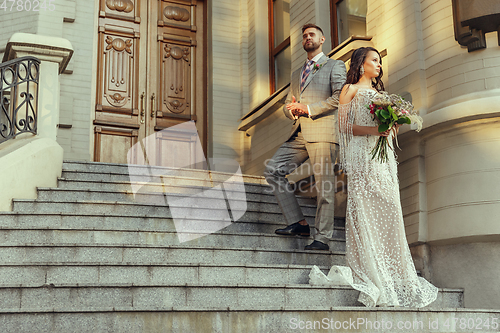 Image of Caucasian romantic young couple celebrating their marriage in city