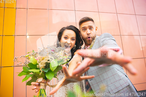 Image of Caucasian romantic young couple celebrating their marriage in city