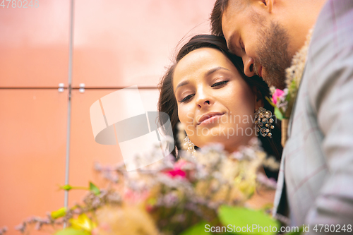 Image of Caucasian romantic young couple celebrating their marriage in city