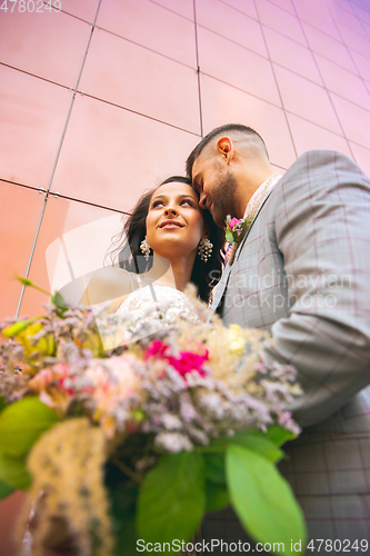 Image of Caucasian romantic young couple celebrating their marriage in city