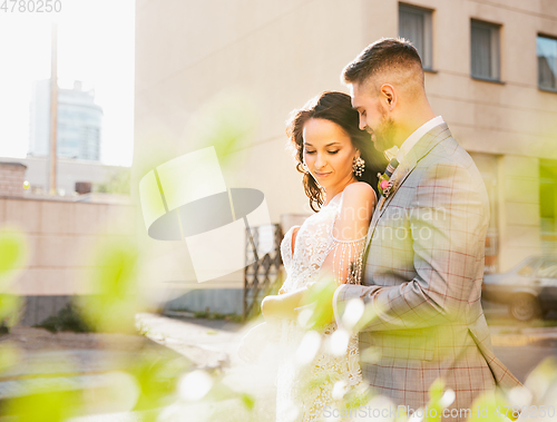 Image of Caucasian romantic young couple celebrating their marriage in city