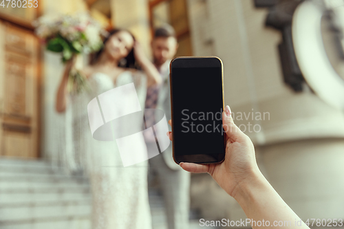 Image of Caucasian romantic young bride celebrating his marriage in city