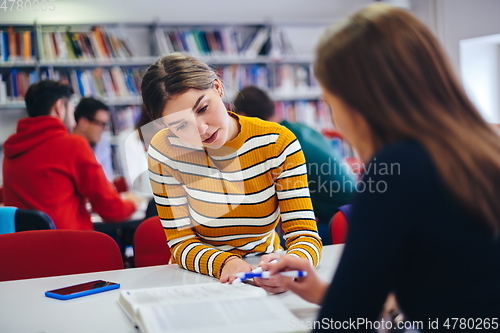 Image of students group working on school project together on tablet computer at modern university