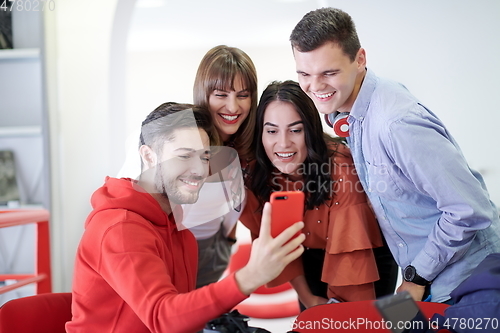 Image of Group of multiethnic teenagers taking a selfie in schoolthe student uses a notebook and a school library