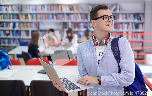 Image of the student uses a notebook, latop and a school library