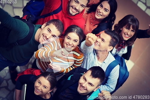 Image of group of happy young people showing their unity.