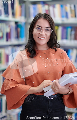 Image of the student uses a notebook and a school library