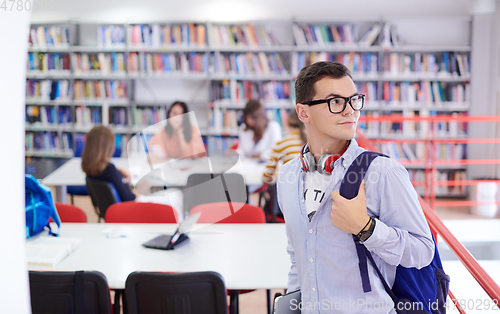 Image of the student uses a notebook, latop and a school library