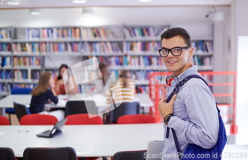 Image of the student uses a notebook, latop and a school library