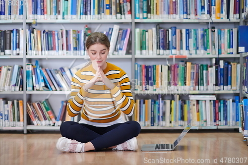 Image of the student uses a notebook and a school library