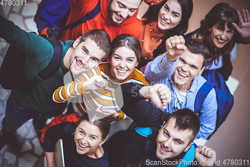 Image of group of happy young people showing their unity.