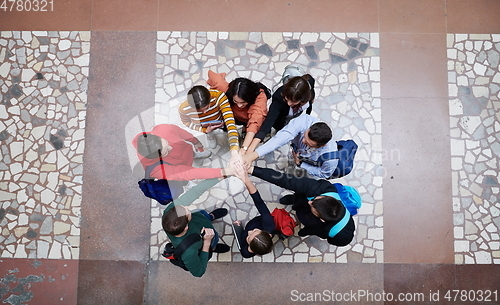 Image of group of happy young people showing their unity.