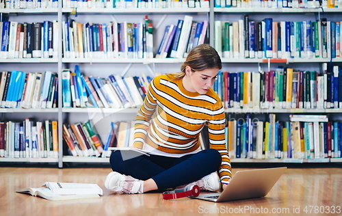 Image of the student uses a notebook and a school library