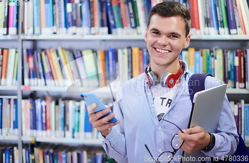 Image of the student uses a notebook, latop and a school library