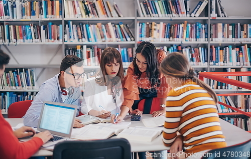 Image of students group working on school project together on tablet computer at modern university